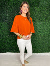 orange top with statement sleeves