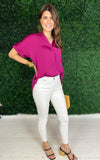 side view of plum top with white skinny jeans