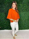 side view of orange top with statement sleeves