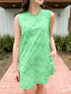 green dress with floral applique and scallop detail 