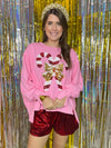 Pink sweater with sequin candy canes