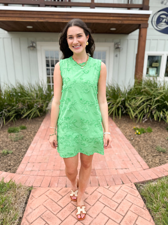 green dress with floral applique