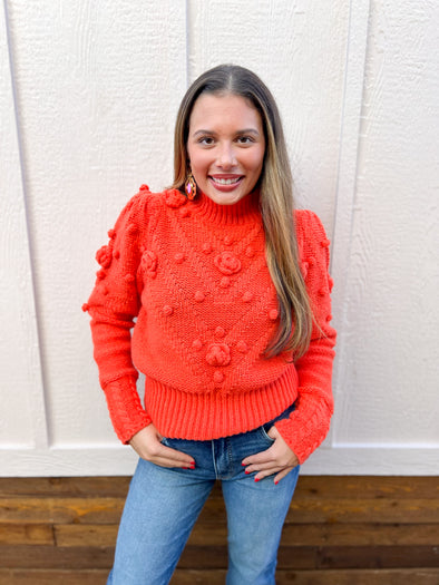 orange pom pom rose sweater