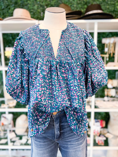 Teal green top with pink and white pattern 