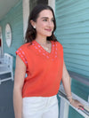 orange v neck short sleeve top 
