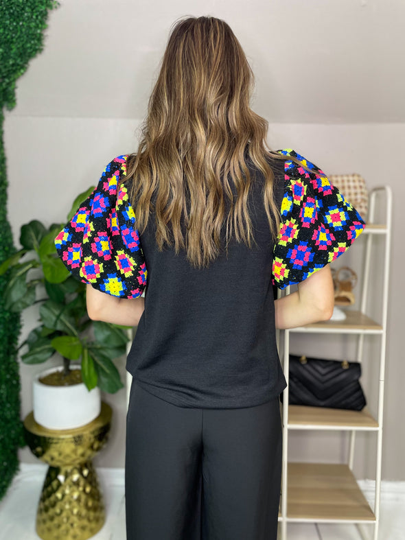 back of black thml top with crochet sleeves
