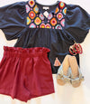 black embroidered top paired with maroon shorts
