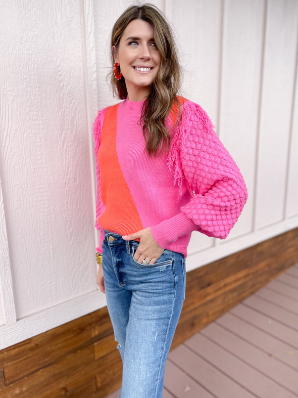 pink and orange sweater with fringe 