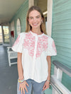 white top with coral embroidery 