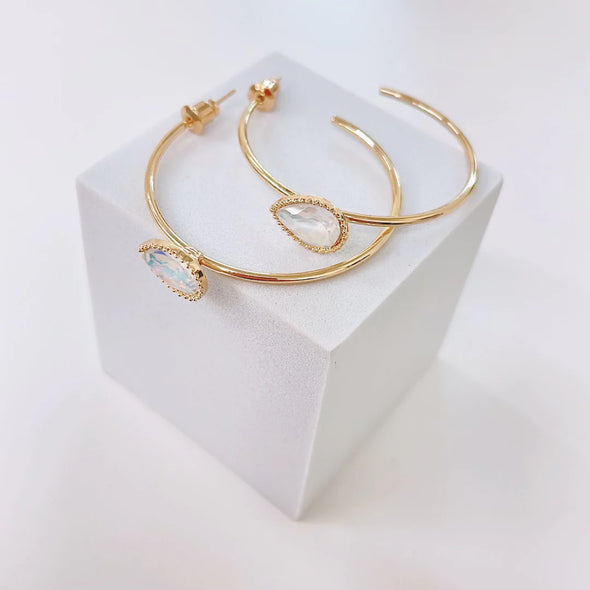 gold hoop earring with iridescent stone 