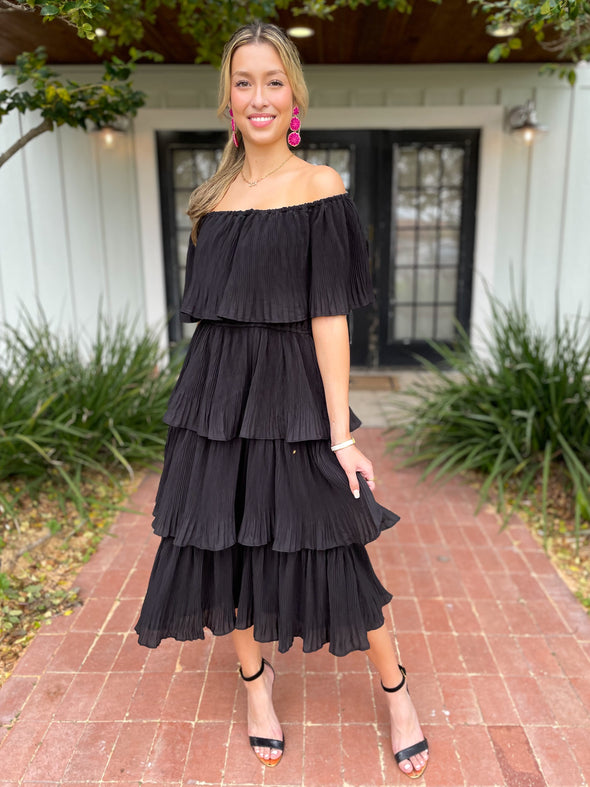 Black off the shoulder midi dress with hot pink earrings 
