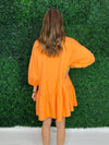 Back of orange tiered mini dress