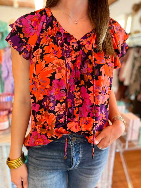 close up of black and fuchsia floral top 