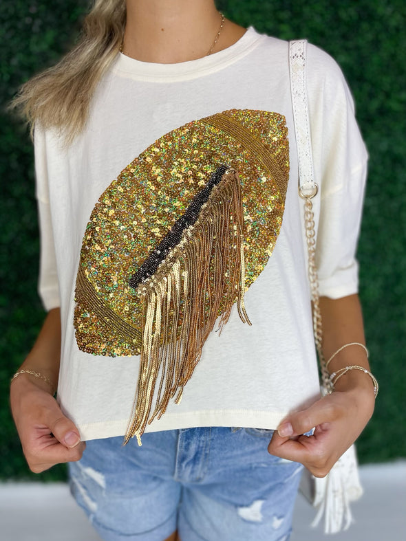 close up of gold sequin football tee with fringe